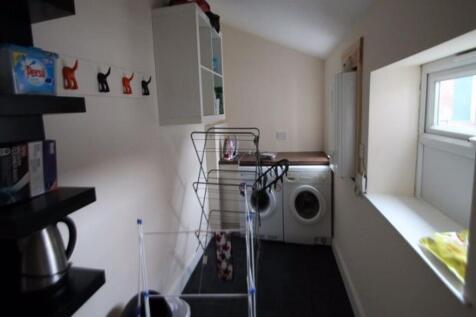 A functional bathroom with a washing machine an...