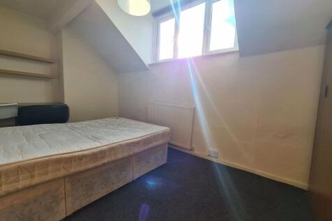 A cozy bedroom with a spacious bed, bright natu...