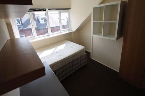 A cozy single bedroom featuring a comfortable b...