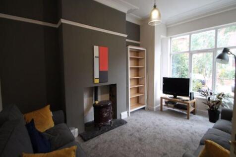 A bright and spacious living room featuring a l...