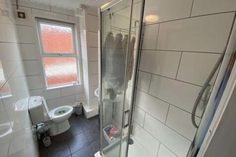 A clean and well-maintained bathroom with a sho...