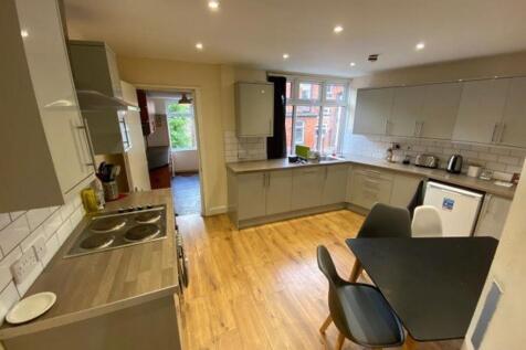 Modern and well-lit kitchen with ample workspac...