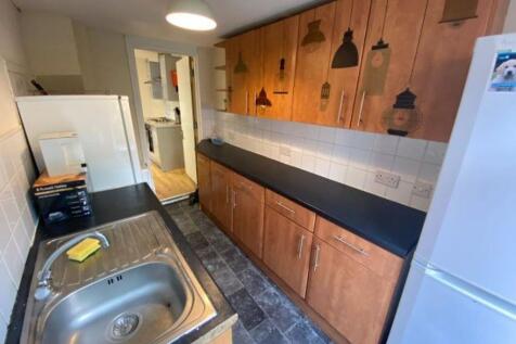 A well-maintained kitchen with wooden cabinets,...