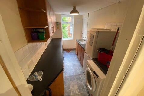 A compact kitchen area with a washing machine a...
