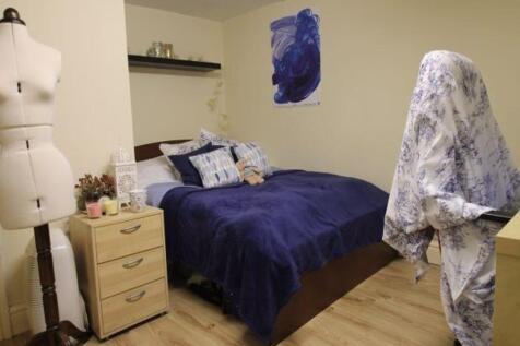 A cozy and well-maintained bedroom featuring a ...