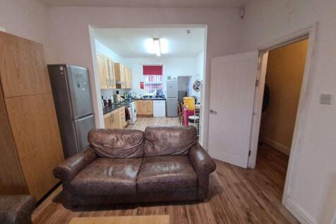 A cozy living room featuring a comfortable brow...