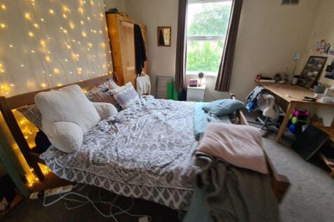 A spacious and inviting double bedroom featurin...