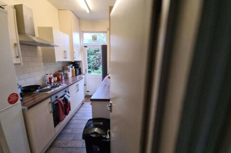 A well-organized kitchen featuring white cabine...
