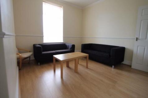 A bright and welcoming living room featuring tw...