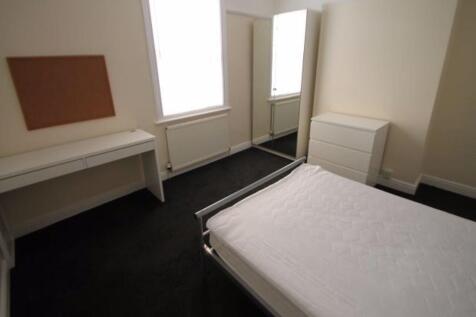 A neatly presented bedroom with a comfortable b...