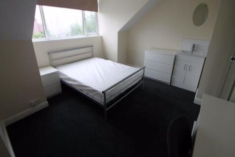 A tidy bedroom featuring a double bed, with a l...