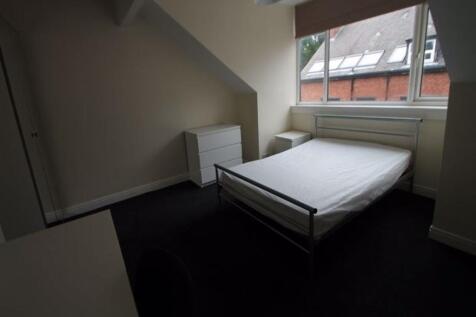 A neat, well-lit single bedroom featuring a com...