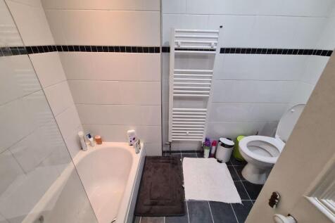 A well-maintained bathroom with a spacious bath...