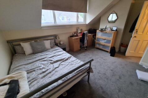 A cozy bedroom with a comfortable bed, ample na...