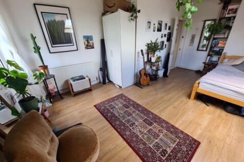 A bright and welcoming living room featuring a ...