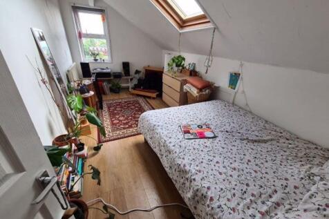 A cozy and well-maintained bedroom featuring a ...
