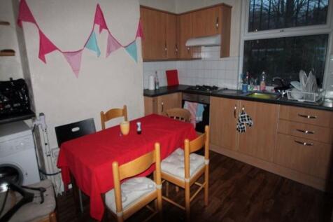 A well-maintained kitchen with wooden cabinets,...