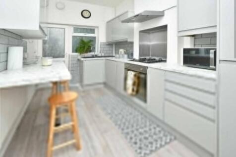 Modern and bright kitchen featuring sleek white...