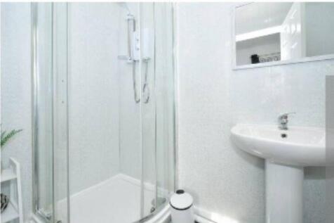A clean and modern bathroom with a compact show...