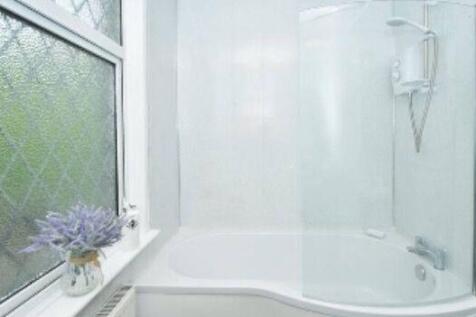 Bright and clean bathroom featuring a large bat...