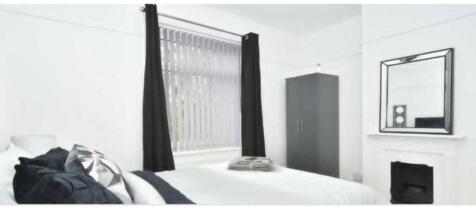 A bright and tidy double bedroom featuring a la...