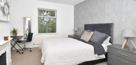 A stylish and modern bedroom featuring a large ...