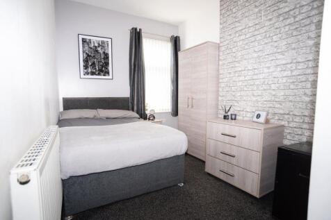 A modern, well-maintained bedroom with a comfor...