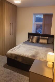 Bright, neatly furnished double bedroom with a ...