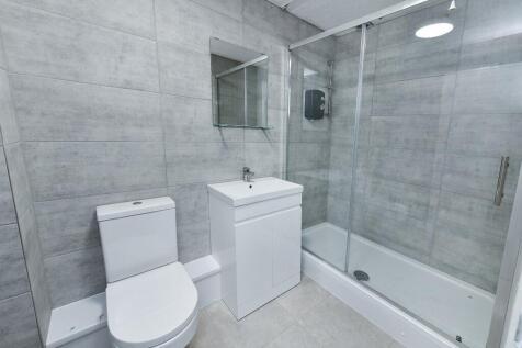 Modern and clean bathroom featuring a toilet, a...