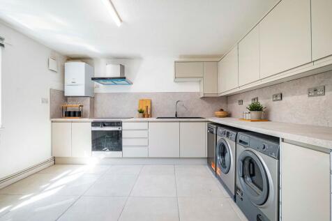 Bright and modern kitchen with ample counter sp...