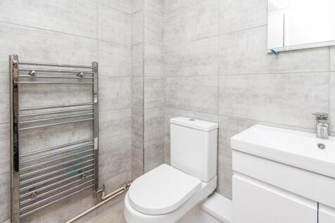 A modern bathroom featuring sleek tiles, a styl...