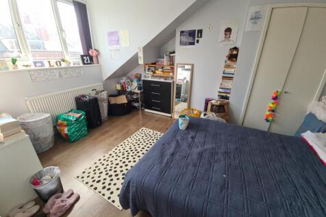 Bright and cozy master bedroom featuring a larg...