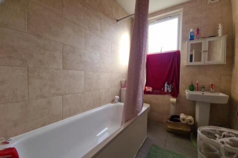 A bright bathroom suite featuring a full bathtu...