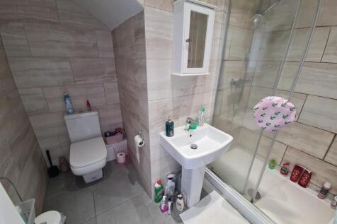 A clean and modern bathroom featuring a glass-e...