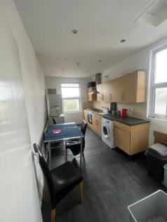 A functional kitchen featuring wooden cabinets,...