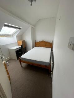 A simple, neatly maintained small room with a s...