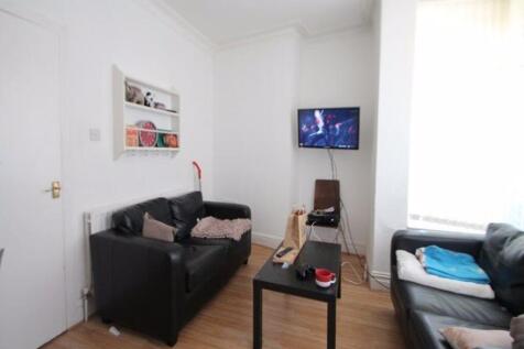 A bright and inviting living room featuring com...