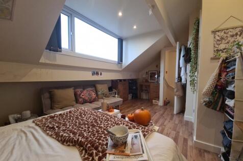 A spacious, well-lit contemporary living room w...