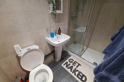 A clean and modern bathroom featuring a toilet,...