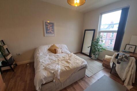 Bright and inviting master bedroom with ample n...