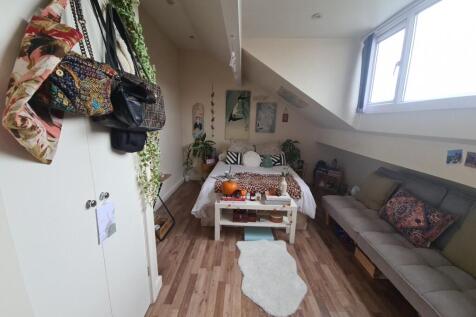 A cozy and well-maintained living room with nat...