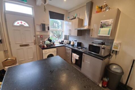 A modern and well-lit kitchen with appliances a...