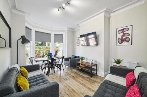 Bright and modern living room featuring large w...