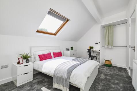 Bright and spacious master bedroom featuring a ...