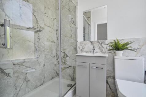 A clean and modern bathroom with a step-in show...