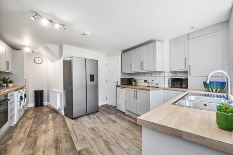 A bright and modern kitchen with white cabinetr...