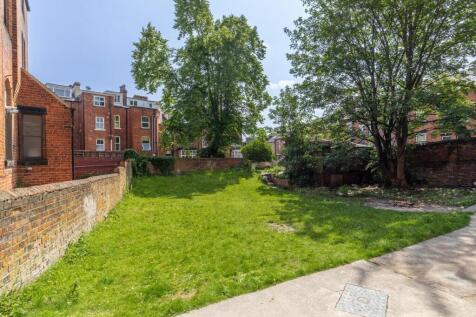 A well-maintained outdoor garden area featuring...