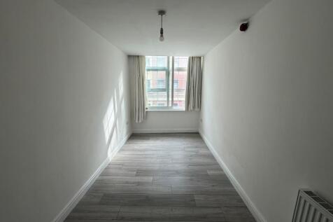 Bright and airy living room with large window a...
