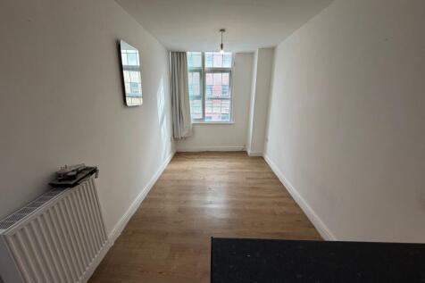 Bright and airy living room with large window a...