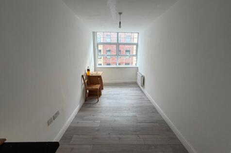 Bright and spacious bedroom with a large window...